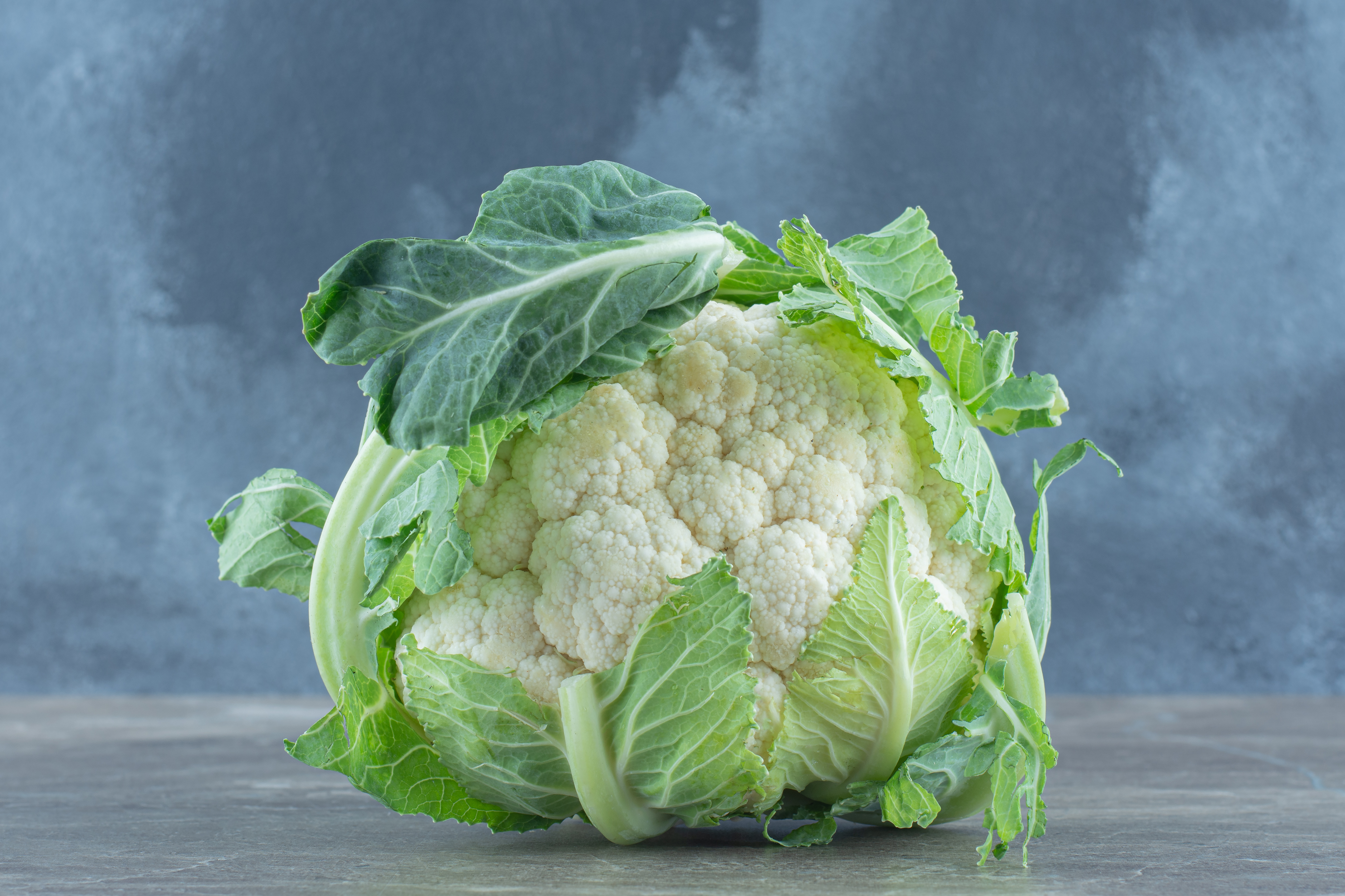 close-up-photo-green-fresh-cauliflower-grey-table.jpg